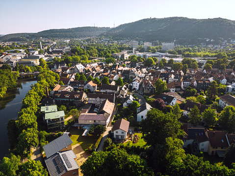 Aerial view of Marburg, Germany with stunning architecture, surrounded by lush greenery and a river valley.