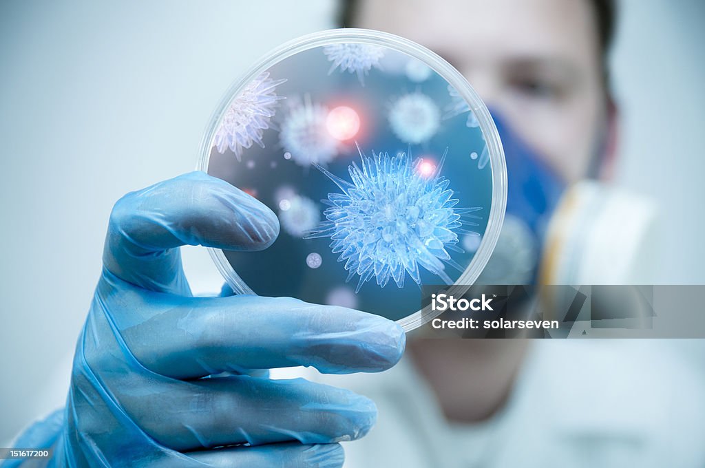 Science and Lab Research A scientist holding a Petri Dish with Virus and bacteria cells. Bacterium Stock Photo