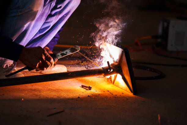 istock welder working with welding on metal with sparking light 1516188969