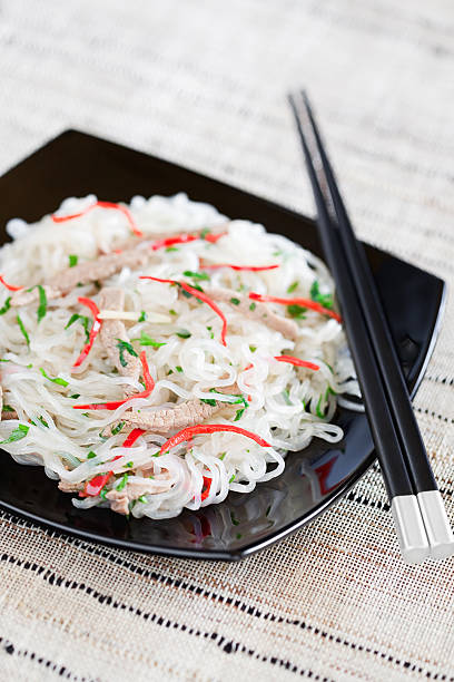 Shirataki noodles with beef, chilli, ginger, garlic and parsley. Selective focus