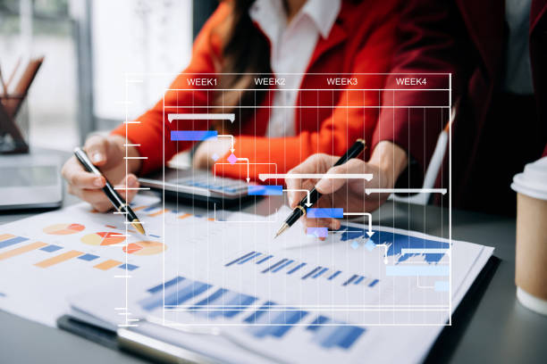 istock Project manager working and update tasks with milestones progress planning and Gantt chart scheduling diagram. business working with smart phone, tablet and laptop in office. 1516205496