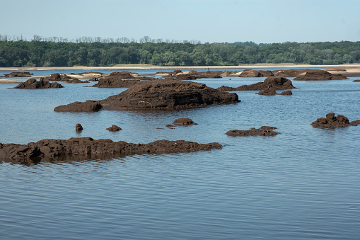 ZAPORIZHYA, UKRAINE - JUNE 17, 2023: View of the hills and debris from the bottom of the dried up river Dnieper in Ukraine. Technogenic disaster in Ukraine. River after the explosion of the Kakhovskaya hydroelectric power station