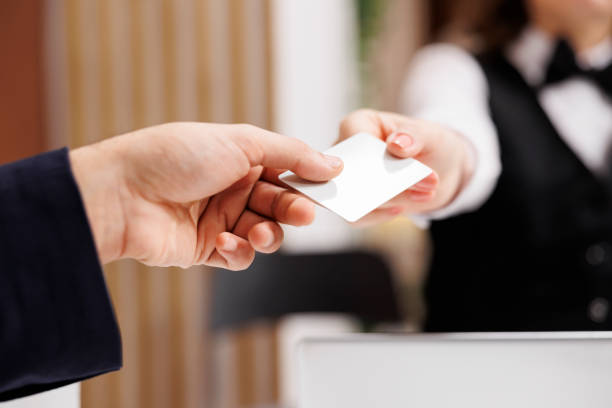 istock Staff handing room access card to client 1516213096