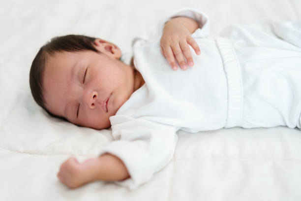 istock newborn baby sleeping on bed 1516227639