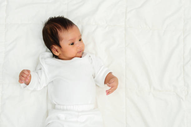 istock happy baby newborn lying and playing on bed 1516227650