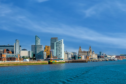 Liverpool city skyline, waterfront and the three graces (The Royal Liver, the Cunard and the Port of Liverpool Buildings) on the River Mersey in North West England, UK.