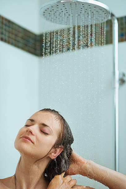 istock Relaxed woman taking shower under water jet 151624965