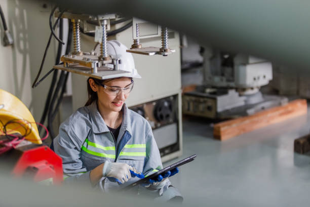 istock Engineers woman use tablet to check condition robotic arm. female technician industrial checking robotic arm machine. futuristic industry production manufacturing. 1516253306