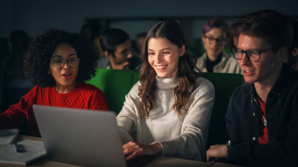 istock Team of Enthusiastic Students Collaborate in University Classroom, Compare Research Project Work on a Laptop Computer. Diverse Scholars Working as a Group on College Homework 1516267324