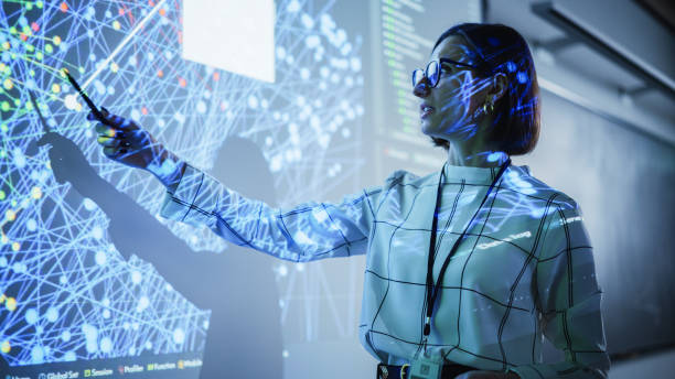 istock Young Female Teacher Giving a Data Science Presentation in a Dark Auditorium with Projecting Slideshow with Artificial Intelligence Neural Network Architecture. Business Startup and Education Concept 1516277094