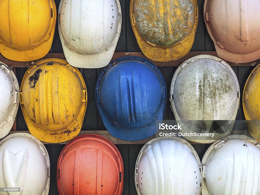 Old used construction helmets Old and worn colorful construction helmets Hardhat Stock Photo