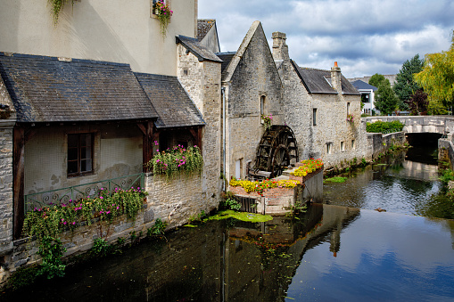 The water mill on the River Aure in the medieval town of Bayeux on the Normandy Coast of France
