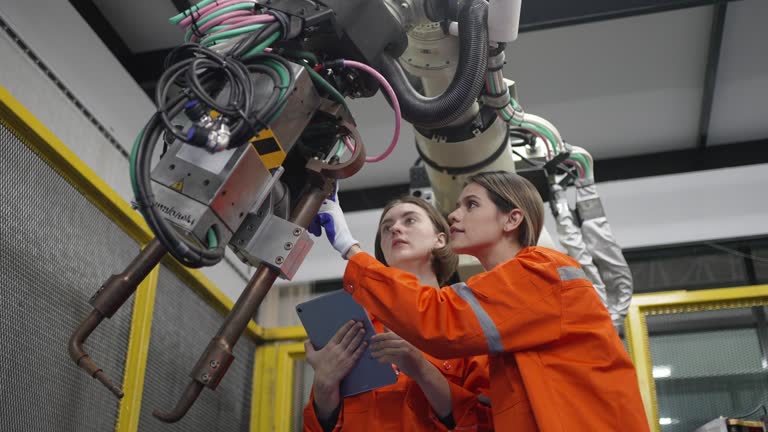 Technician work with robotic arm.