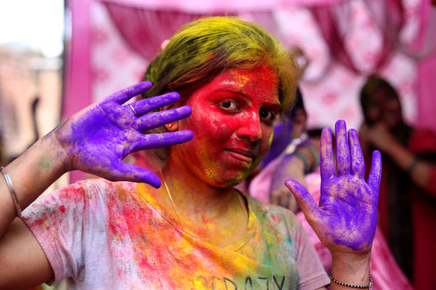 Women showing painted hands on Holi festival, India stock photo