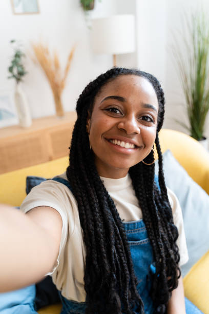 istock Smiling woman taking selfie from home. 1516328150