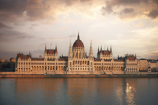 Parliament building in dramatic sky at sunset, Budapest, Hungary.