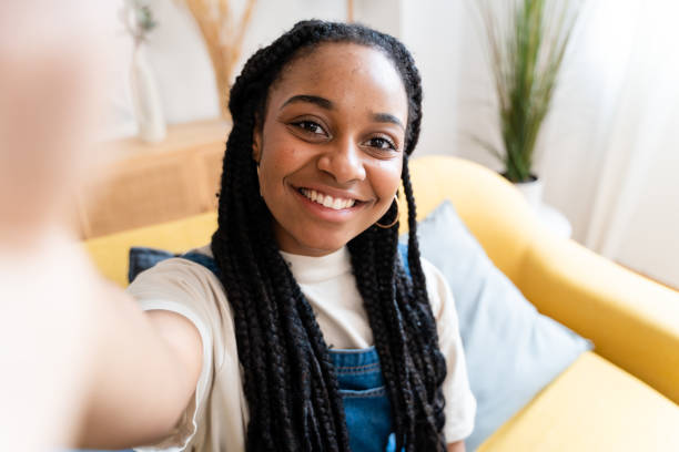 istock Smiling woman taking selfie from home. 1516330327