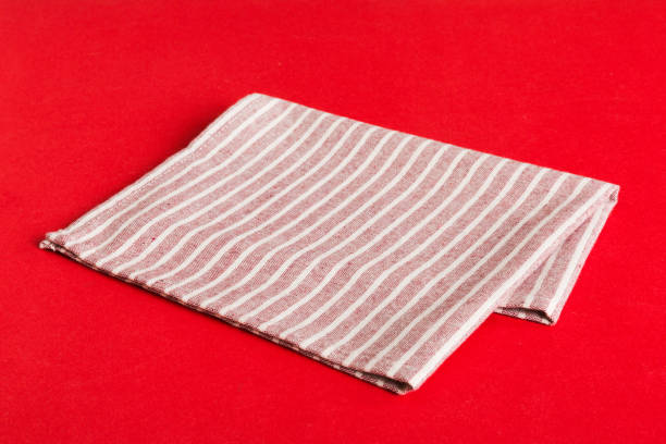 istock top view with red empty kitchen napkin isolated on table background. Folded cloth for mockup with copy space, Flat lay. Minimal style 1516341728
