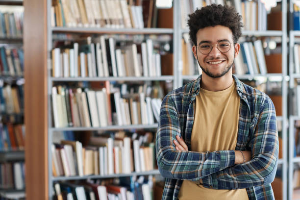 istock Student standing in library at college 1516350835
