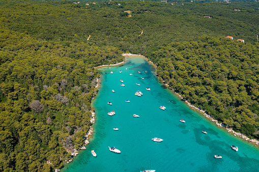 Cifutna Bay on Rab Island, Croatia, with a beach and the boats