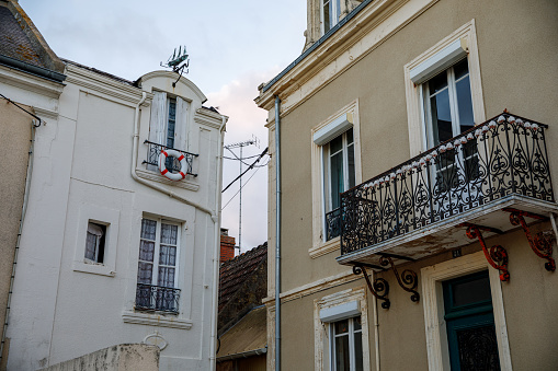 Sunrise view of coastal street of Grandcamp Maisy, a scenic French coastal town in Normandy, with fishing port, sandy beaches, and maritime traditions