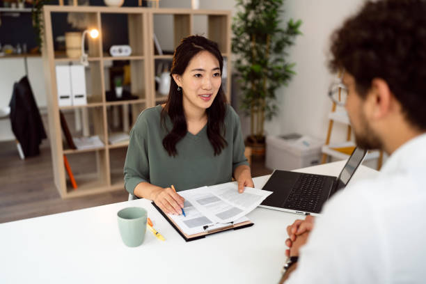 istock Female recruiter Japanese ethnicity interview male candidate 1516367686