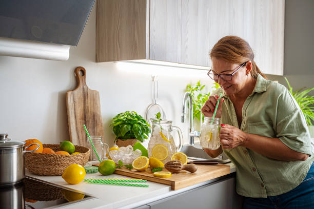 istock Woman drinking fresh lemonade in kitchen 1516378851