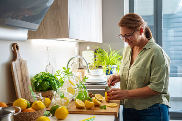 istock Woman cutting lemons for lemonade preparation 1516378887