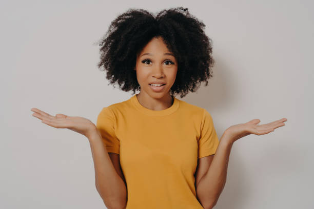 istock Confused doubtful black woman shrugging with shoulders, feeling baffled while looking at camera 1516385463