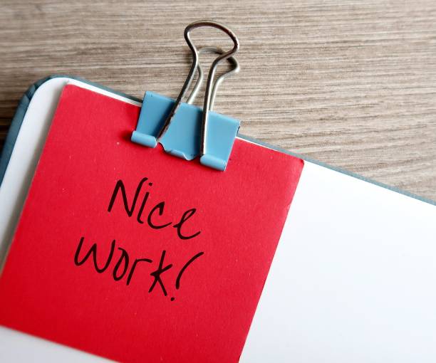 istock Red note clip with document with compliment in handwritting NICE WORK!, concept of giving positive feedback in response to a job well done, compliment to staff from boss or clients, from teacher to student 1516391421