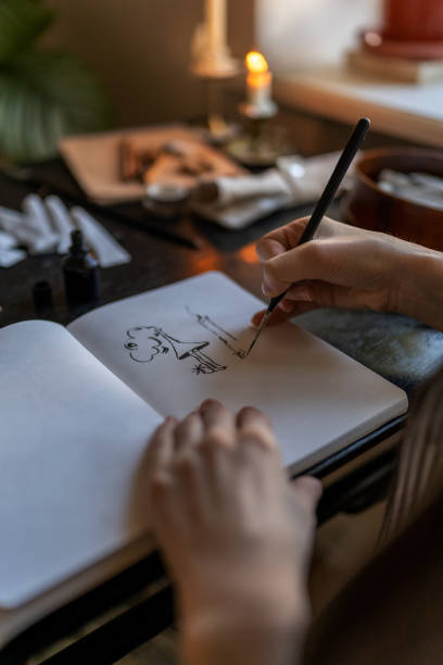 istock Artist holding fountain pen drawing with ink, creating artwork 1516401702