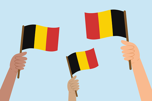 Diverse people hands raising flags of Belgium. Vector illustration of Belgian flags in flat style on blue background.