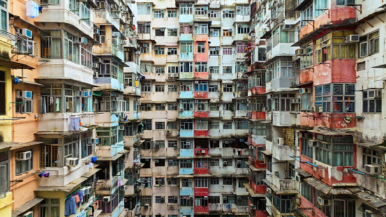 Yick Cheong and Yick Fat old apartment house exterior architecture in Hong Kong city, drone aerial view. Asian people residential life, transformer building or monster building travel landmark