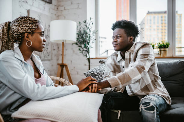 istock Two young people holding hands, showing support and care 1516445835
