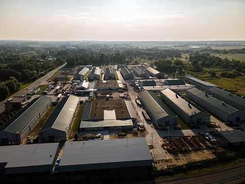 Aerial drone view of small warehouse at sunset