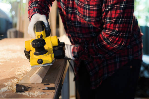 istock hand holding planing tools A front view of a carpenter wearing a plaid shirt. 1516453600