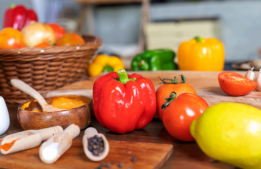 Closeup red bell pepper, tomato, lemon, onion and spices on table ingredients for pizza. Vegetarian food raw materials.