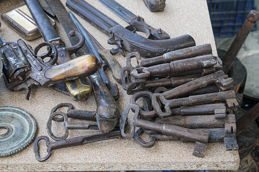 Old wooden door keys and a gun