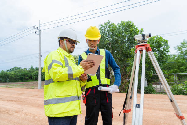 istock The engineer consulted with the contractor on road construction guidelines by using a telescope to find the building level. 1516478187