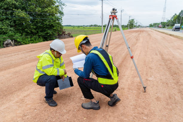 istock Engineers and contractors plan together on site to work on a rural highway road. 1516478732