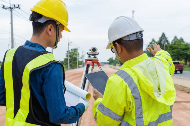istock Engineers and contractors plan together on site to work on a rural highway road. 1516479259
