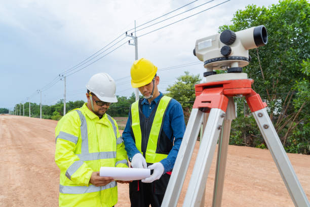 istock Engineers and contractors plan together on site to work on a rural highway road. 1516479265