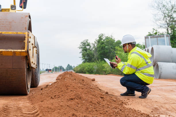 istock An Asian engineer inspects a road roller on site using a walkie-talkie. 1516479797