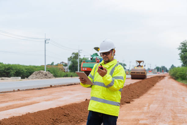 istock An Asian engineer inspects a road roller on site using a walkie-talkie. 1516481356