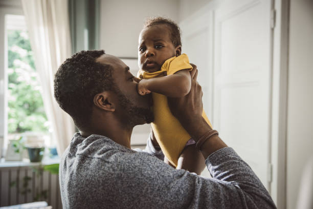 istock Playful father lifting newborn baby 1516483983