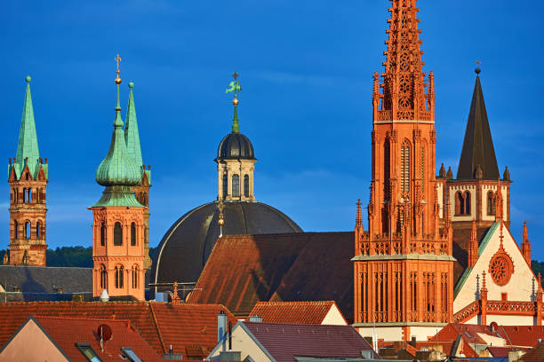Wuerzburg, Germany - July 03, 2023: Towers of the Kiliansdom, the Neumünmster church and the Marienkapelle in Würzburg in the evening.