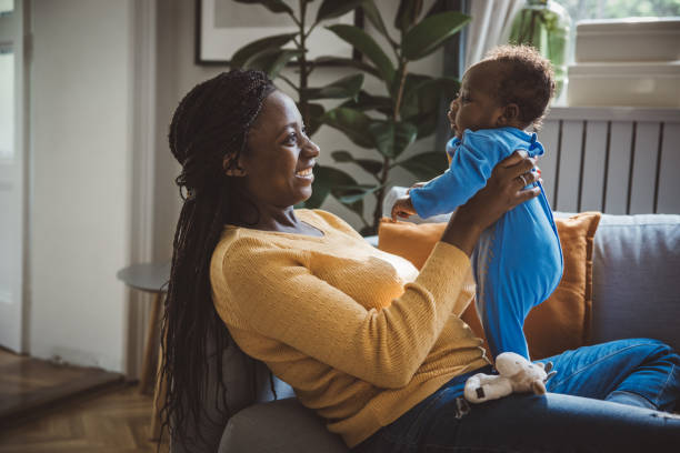 istock Joyful Mother Playing with Baby 1516487205