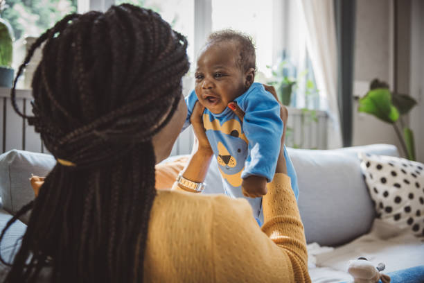 istock Joyful Mother Playing with Baby 1516487431