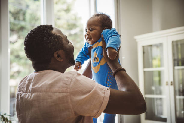 istock Young father with baby at home 1516505202