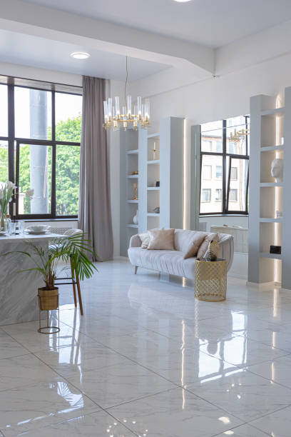 istock minimalistic light elegant luxury design of a modern spacious studio apartment with kitchen area, bedroom and huge mirror behind the couch. tiles on the floor and high ceiling. 1516509441
